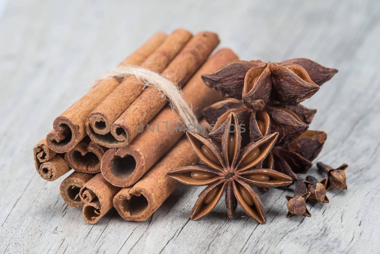 Cinnamon sticks and star anise on a wooden background