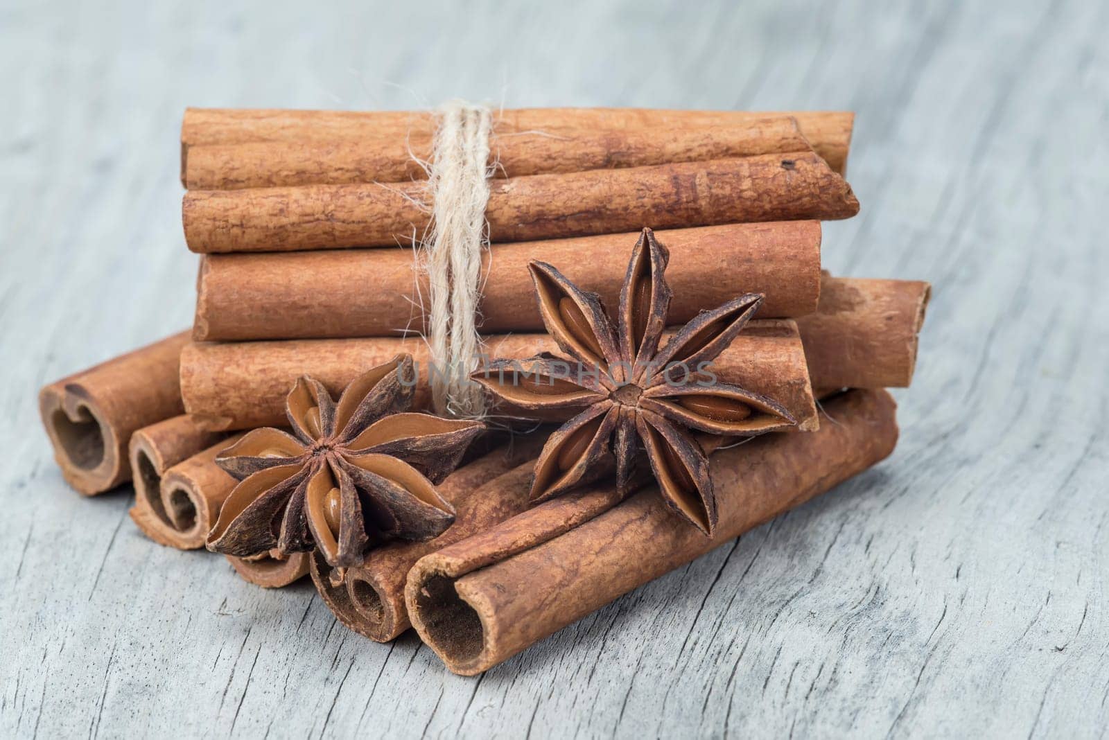 Cinnamon sticks and star anise on a wooden background