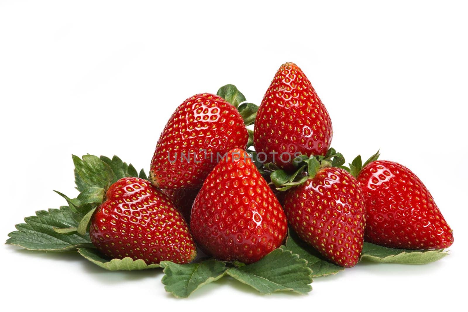 Strawberries with their leaves isolated on a white background
