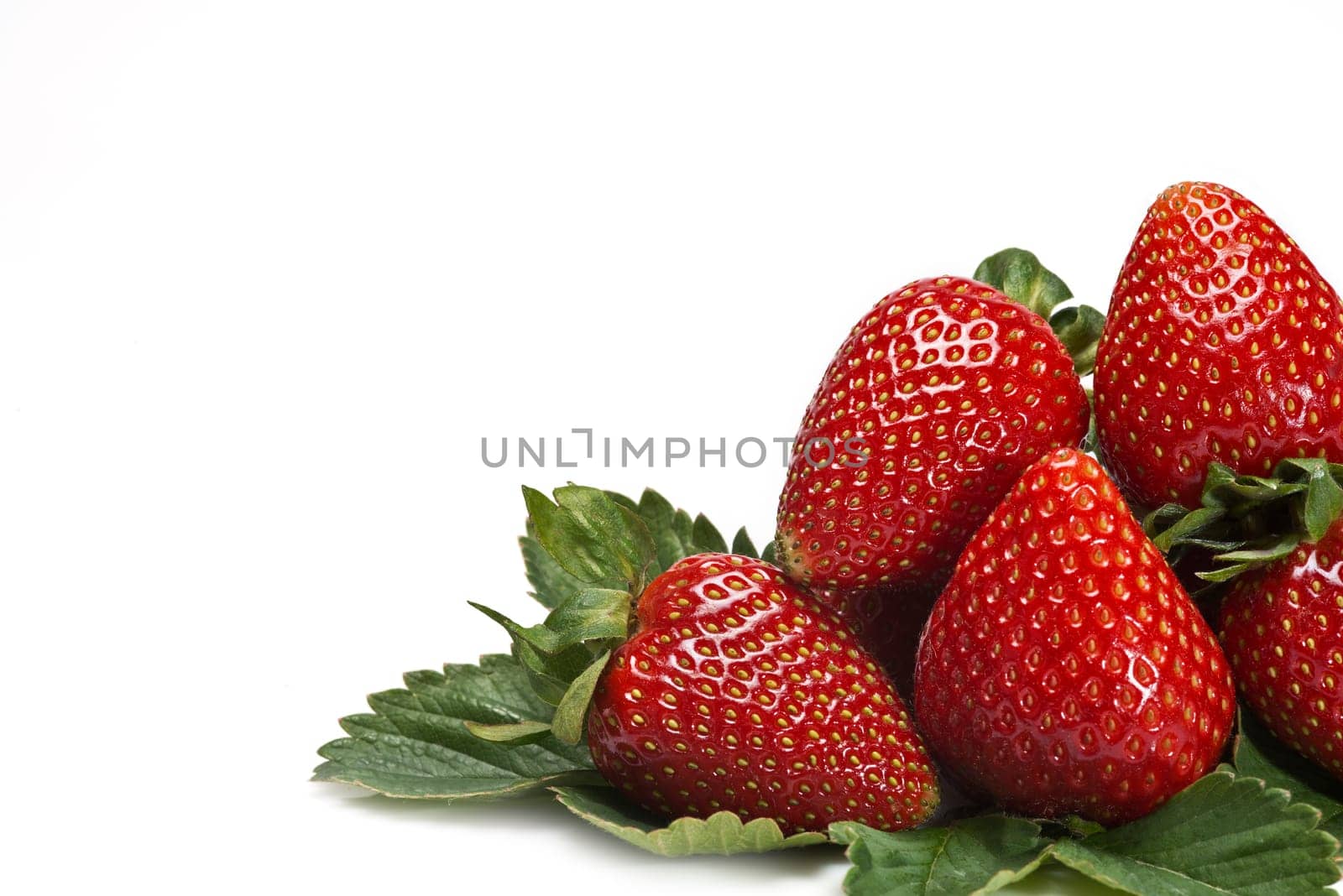 Strawberries with their leaves isolated on a white background