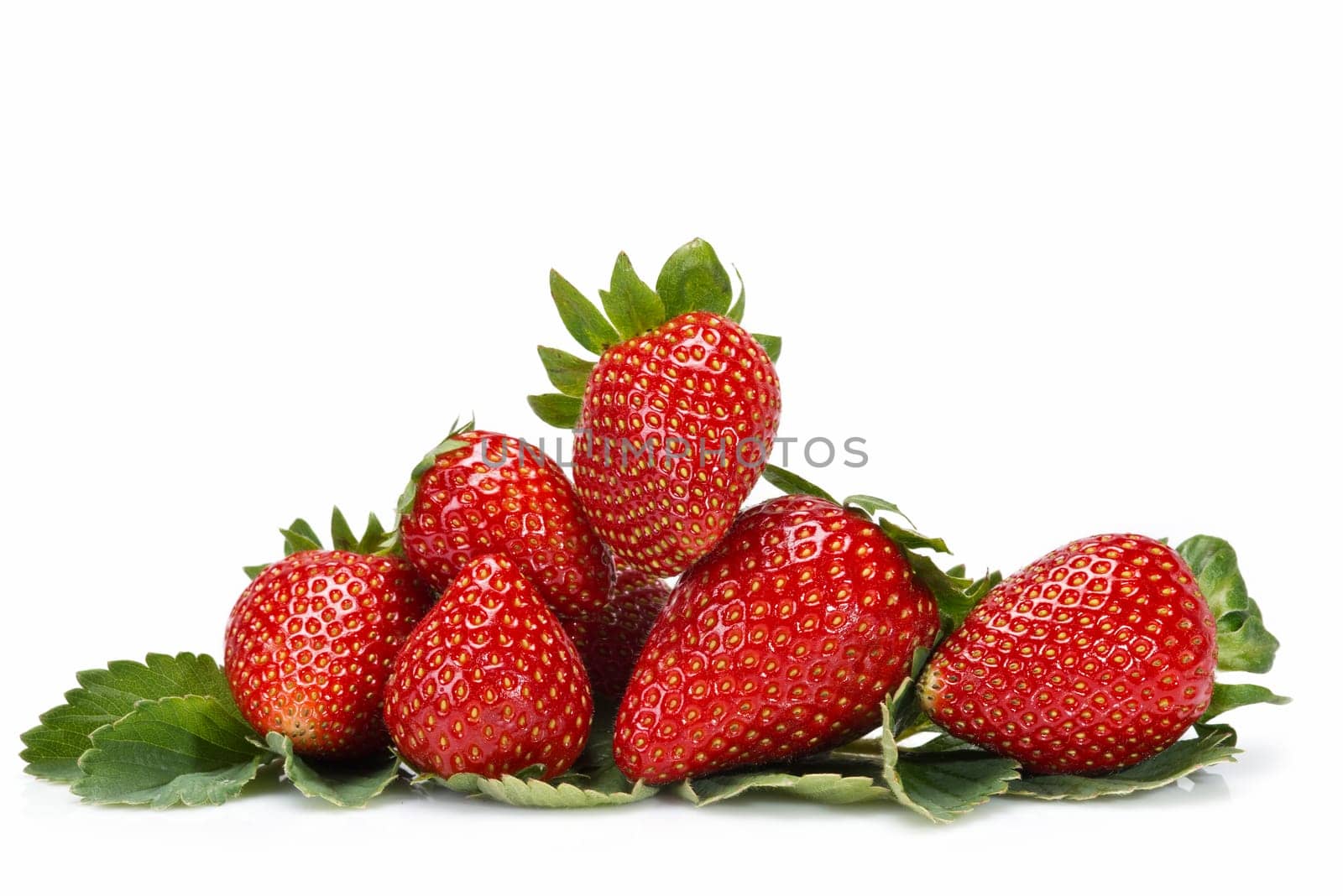Strawberries with their leaves isolated on a white background