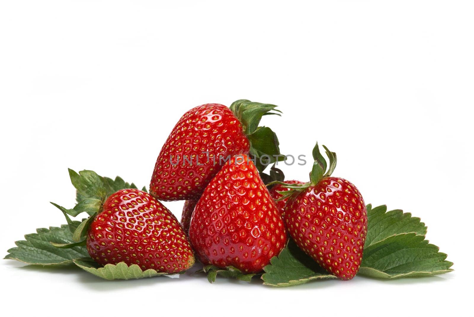 Strawberries with their leaves isolated on a white background