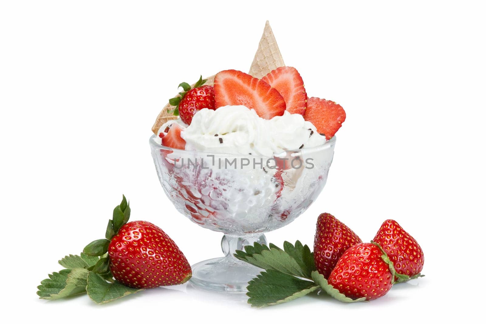 Strawberries and whipped cream cup isolated over a white background.