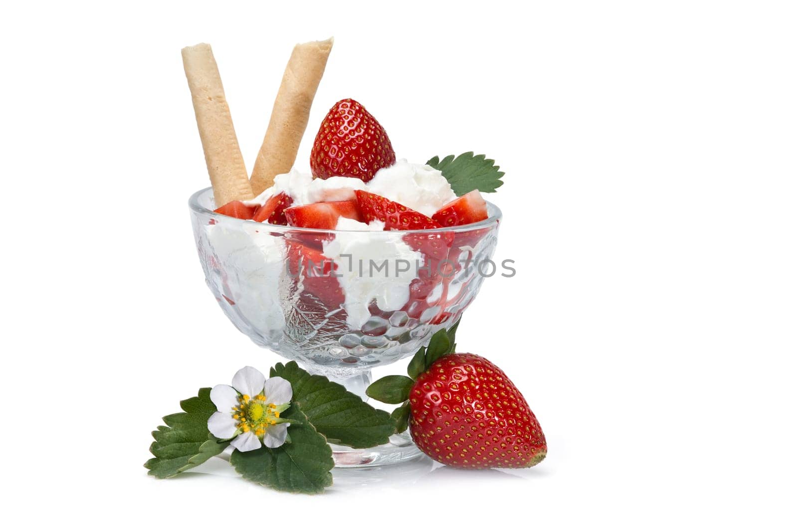 Strawberries and whipped cream cup isolated over a white background.