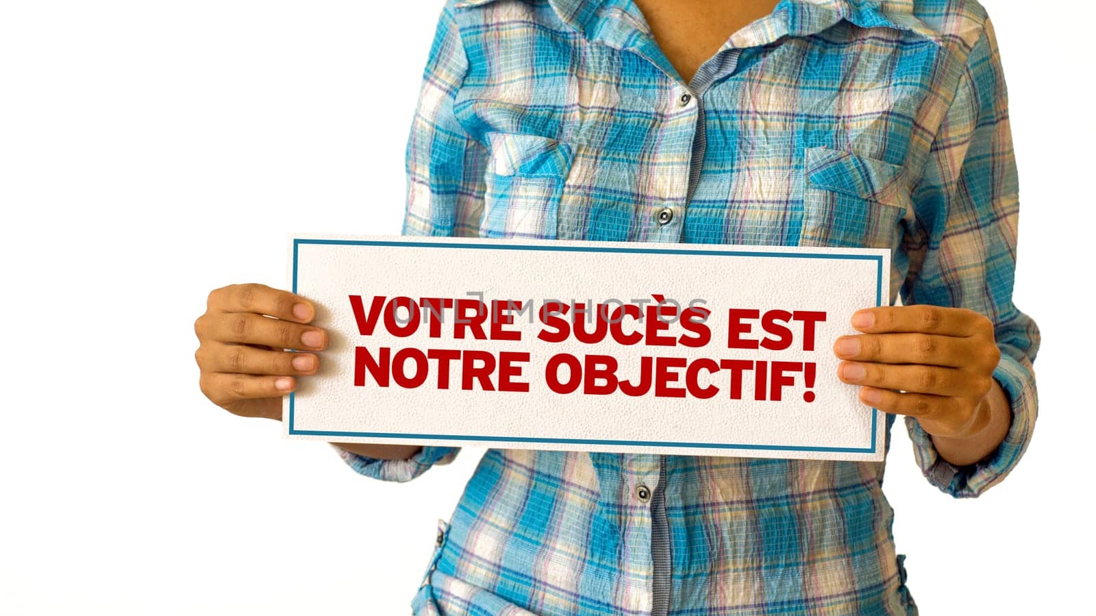 A woman holding a Your Success is our Goal sign.