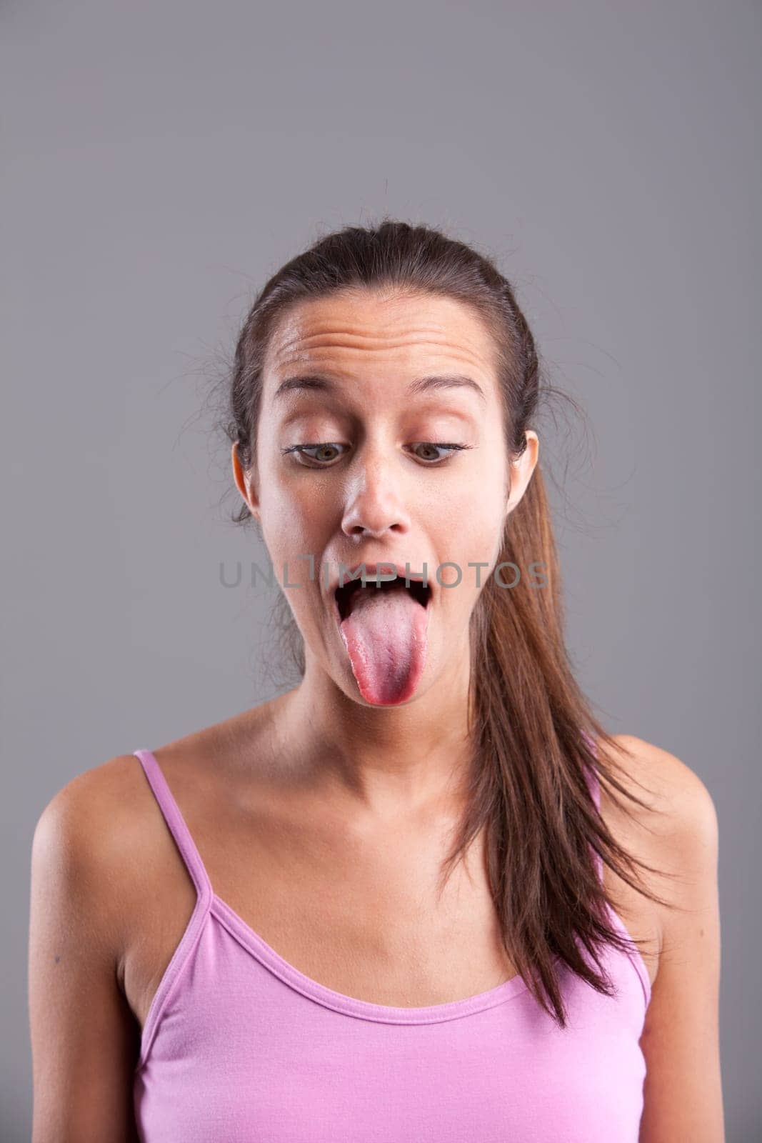 Funny pretty girl with the tongue stuck out