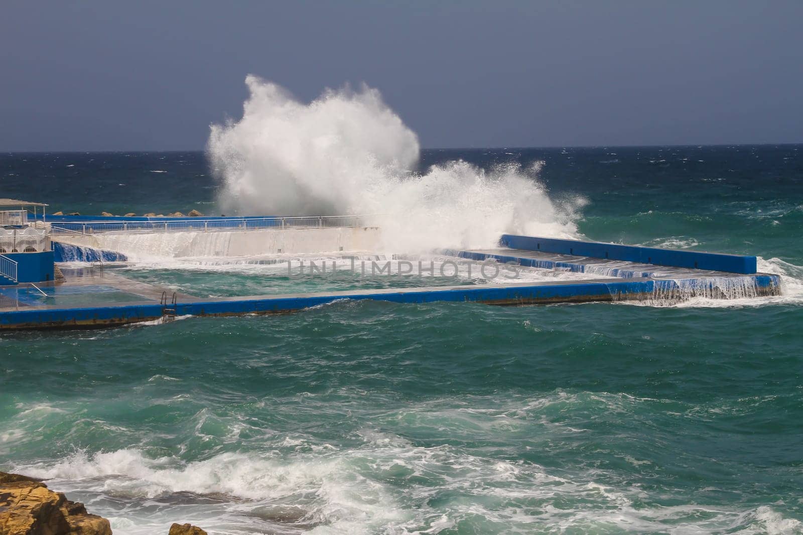 Huge waves getting into the swimming pool.