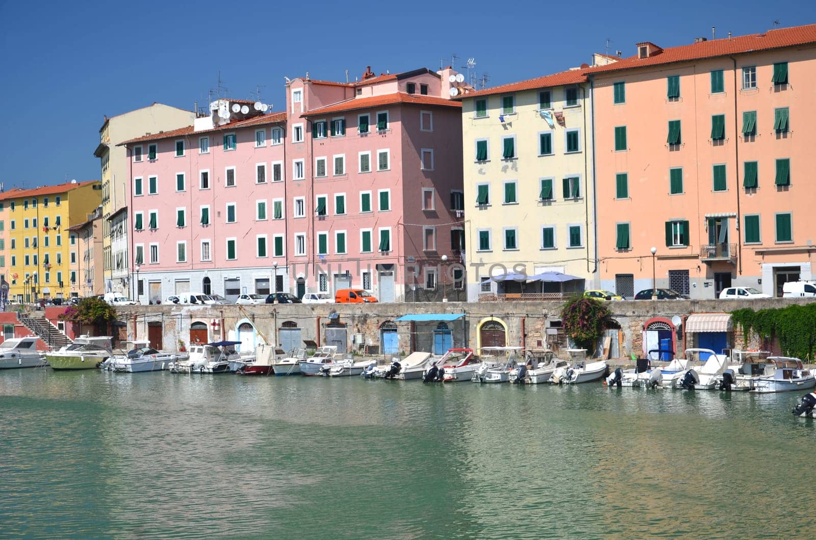 Picturesque view on boats in city channel in Livorno, Italy