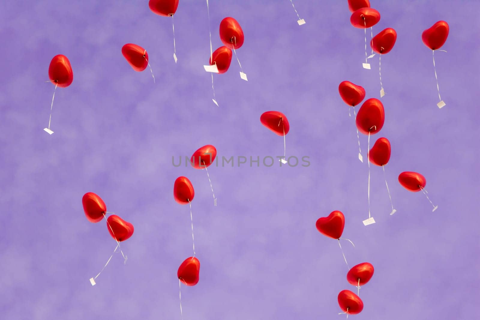 A group of beautiful heart ballons in front of a purple sky. Perfect for illustrating e.g. weddings, Valentine's Days or anniversaries.