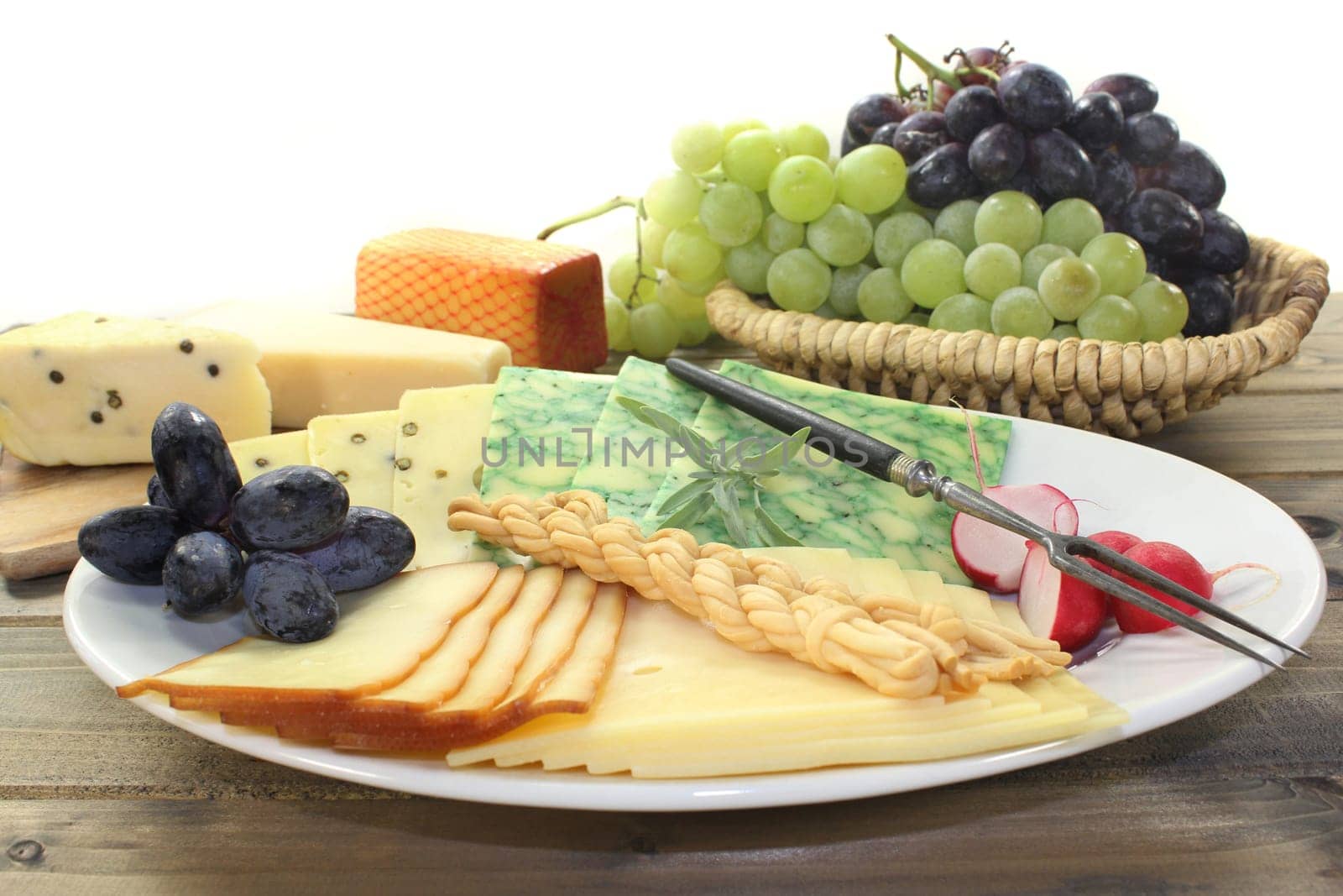 a white plate with different cheeses