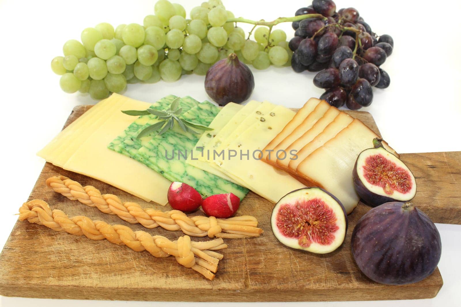a wooden board with different cheeses