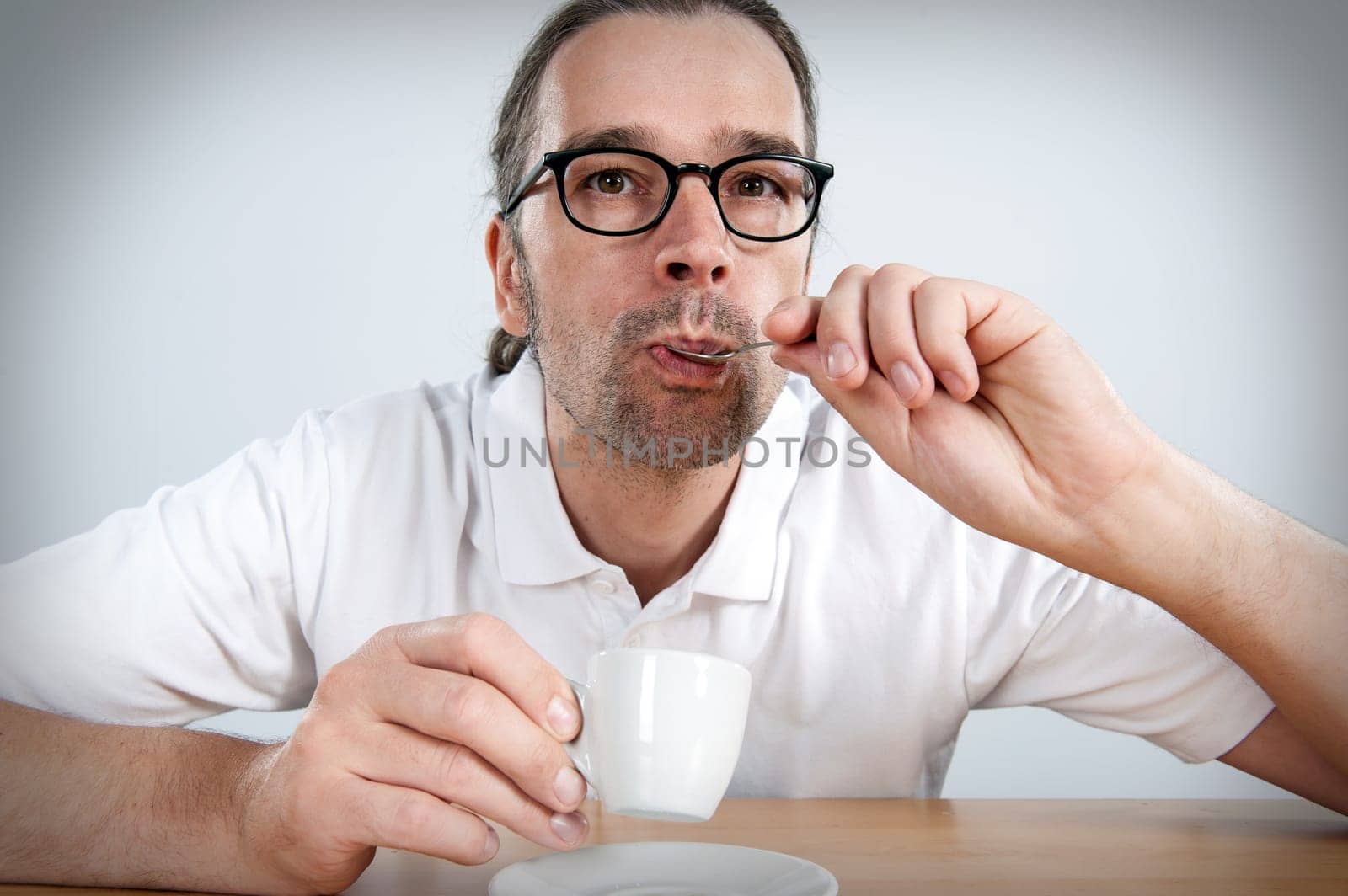 Man is drinking espresso