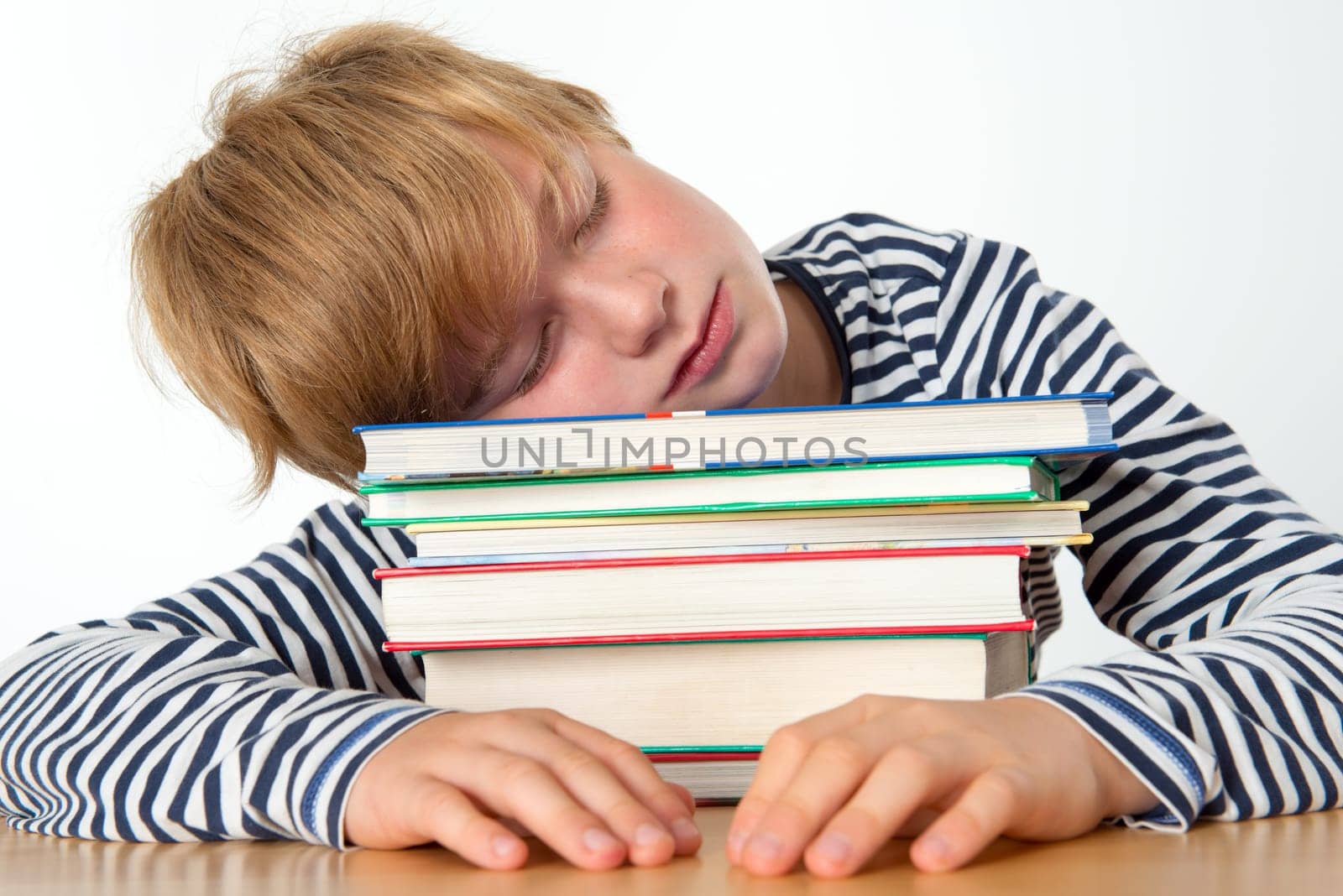 boy is sleeping on his books