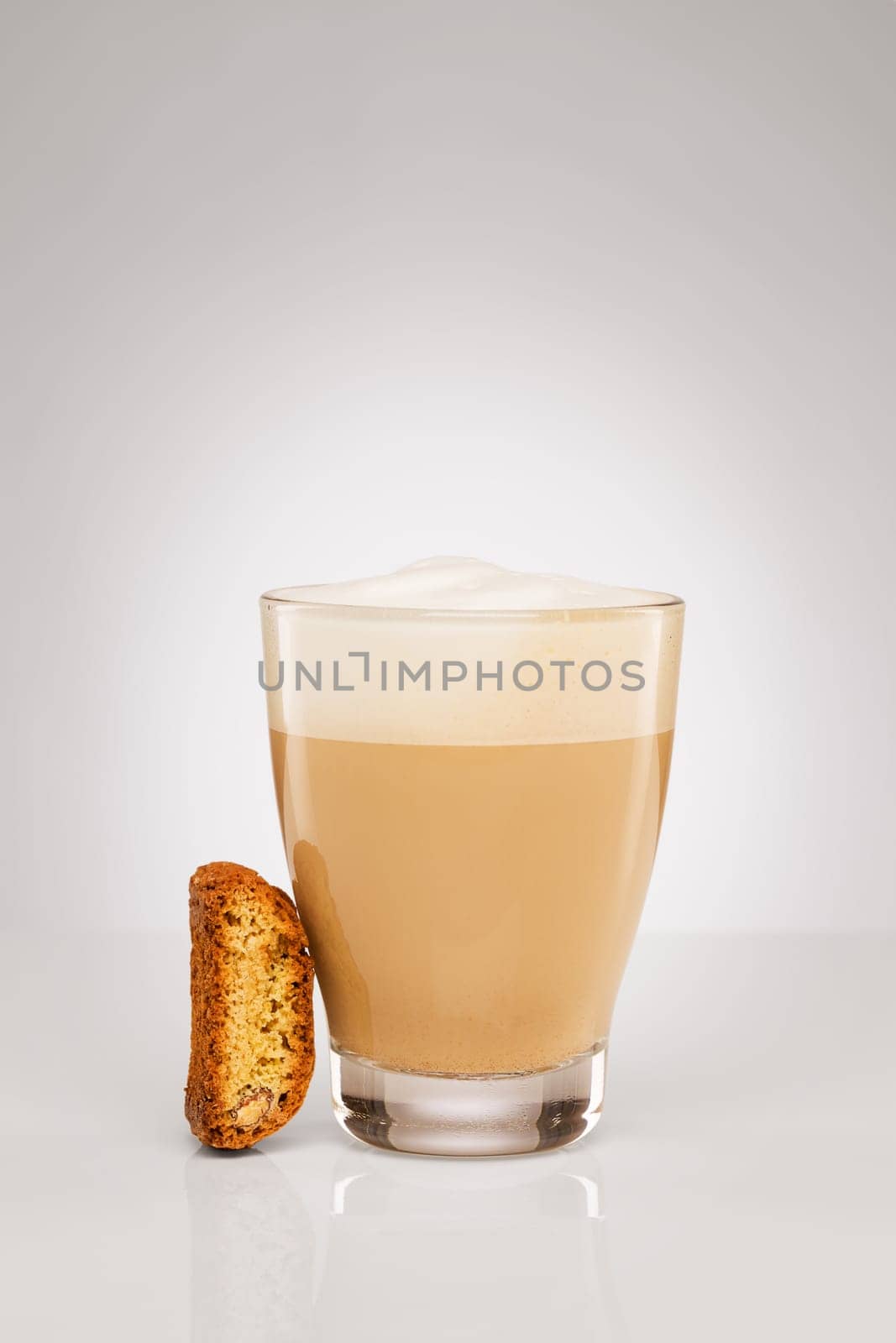 Small cappuccino with cantuccini biscuit on grey background