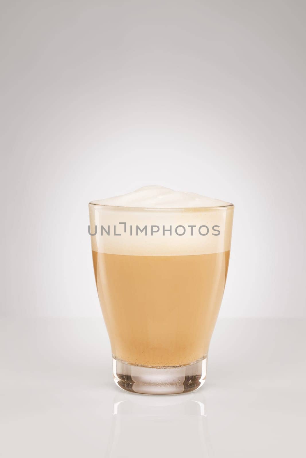Small cappuccino on grey background