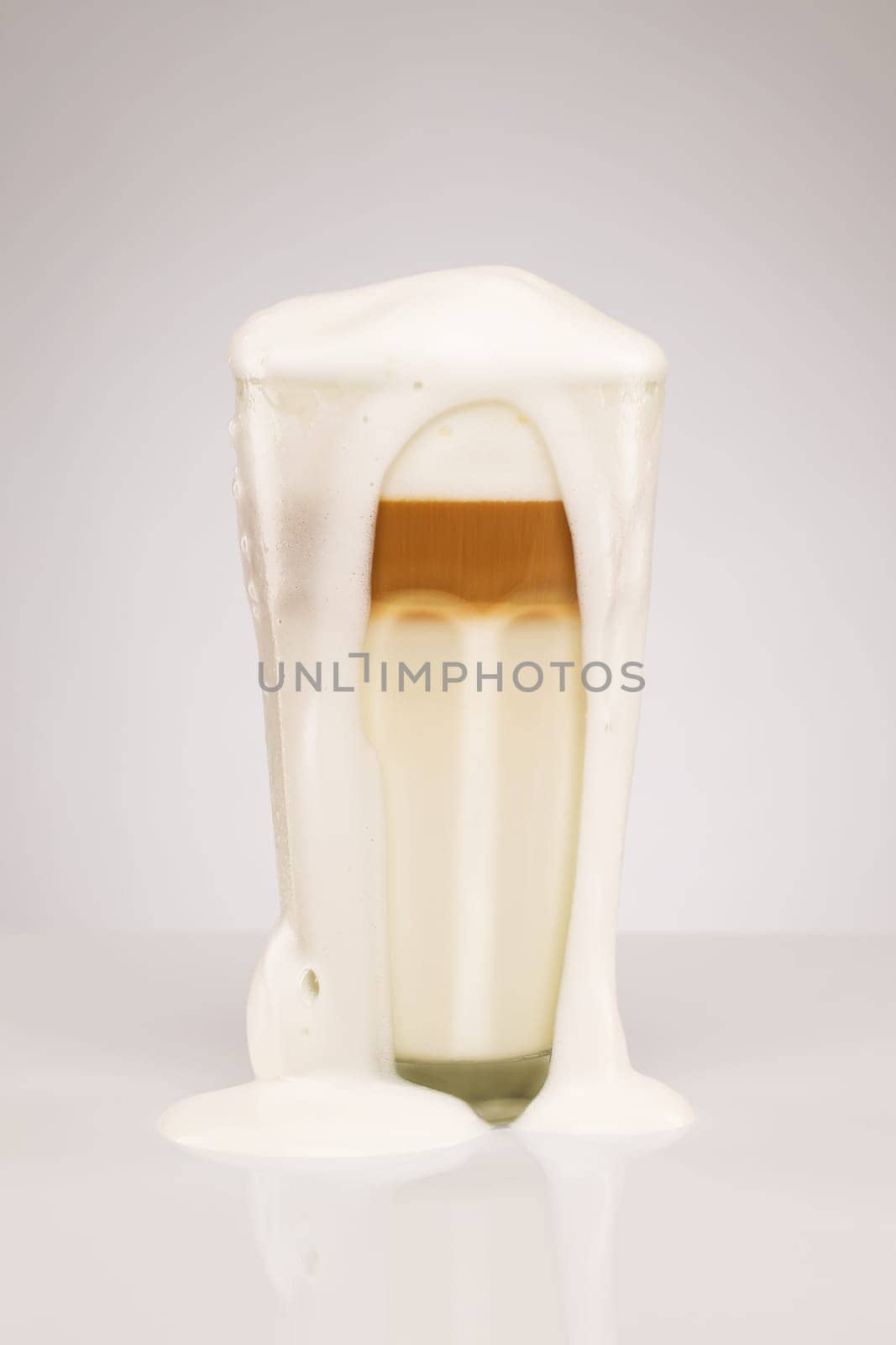 Exuberant latte macchiato on grey background