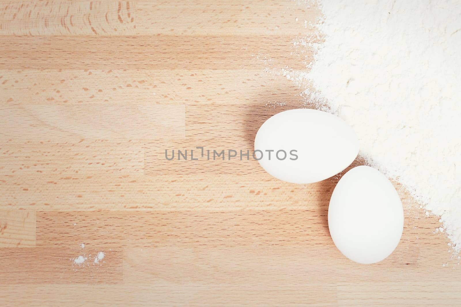 Eggs for baking next to flour from above with text space