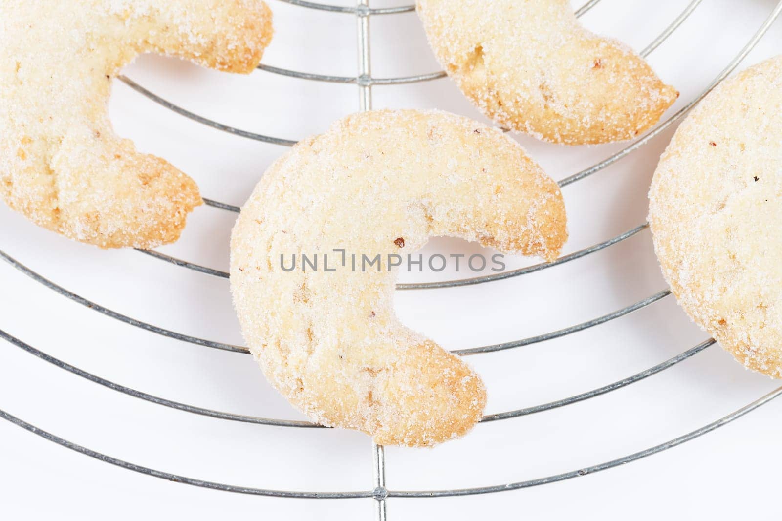 Close-up of vanilla crescents from above on cake rack