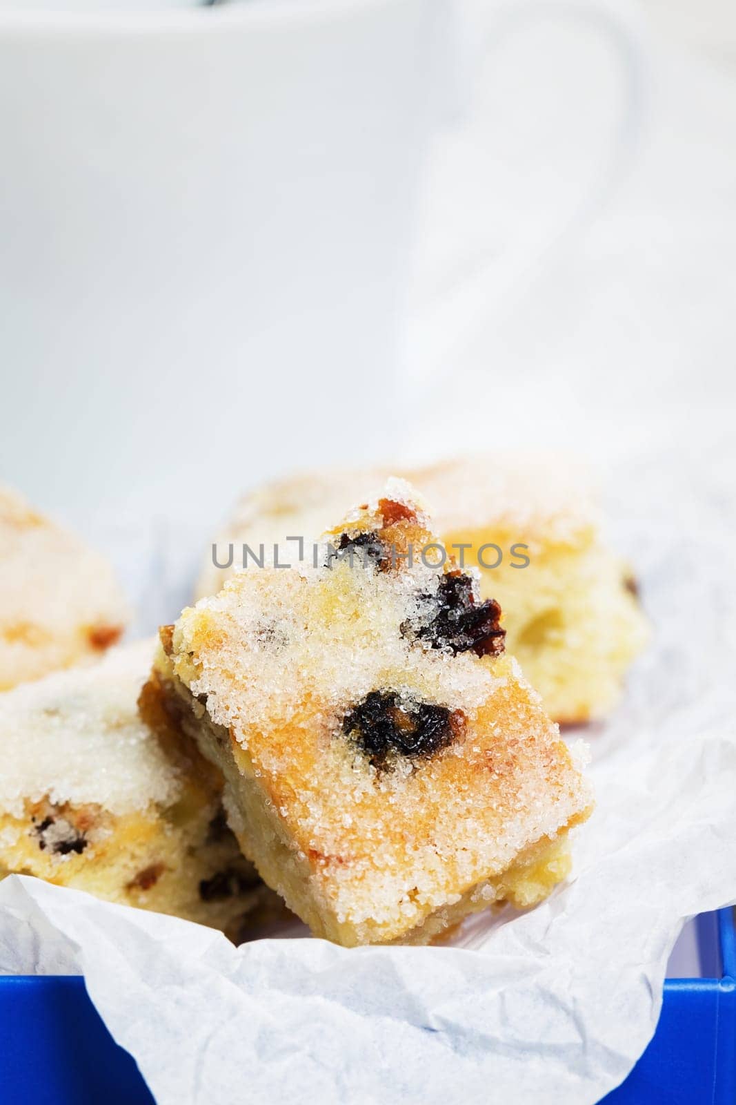 Close-up of small piece of Christmas stollen on baking paper