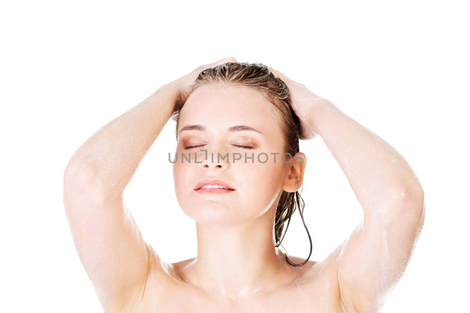 Young fit woman in shower washing her body