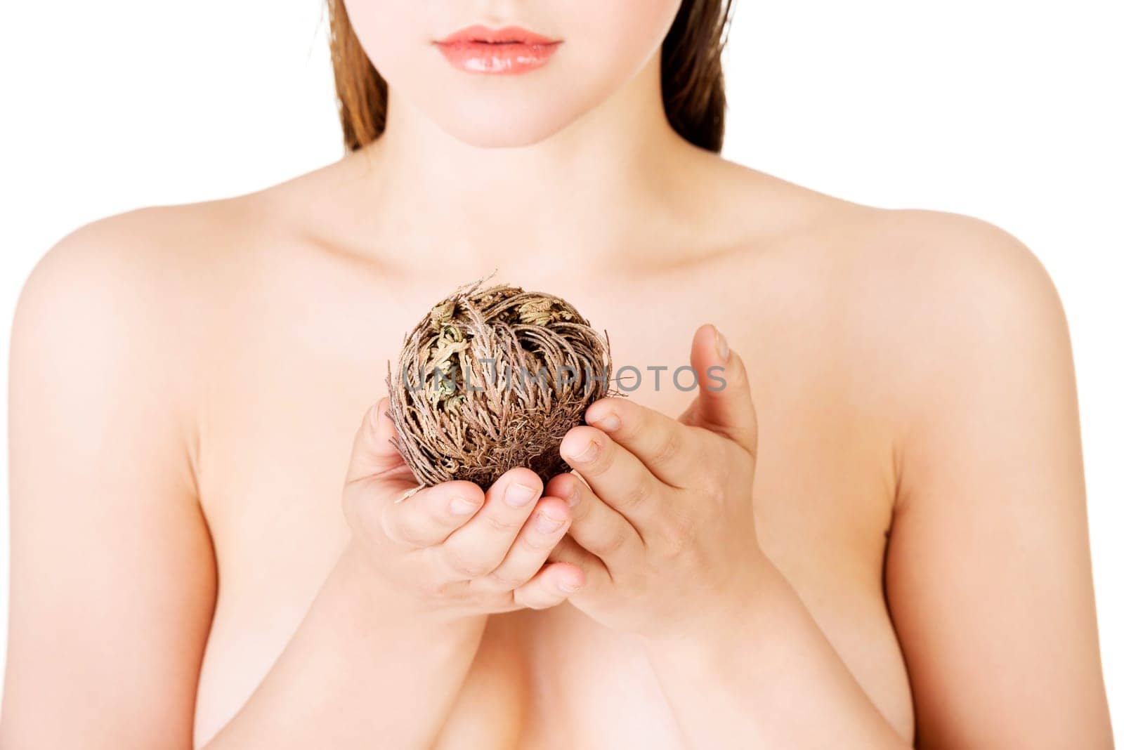 Beautiful spa woman holding Rose of Jericho