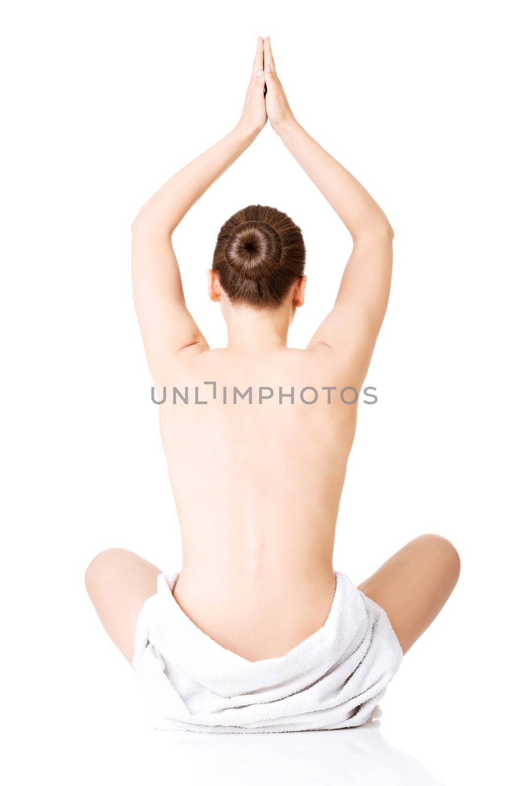 Young beautiful nude woman with towel practicing yoga , isolated on white