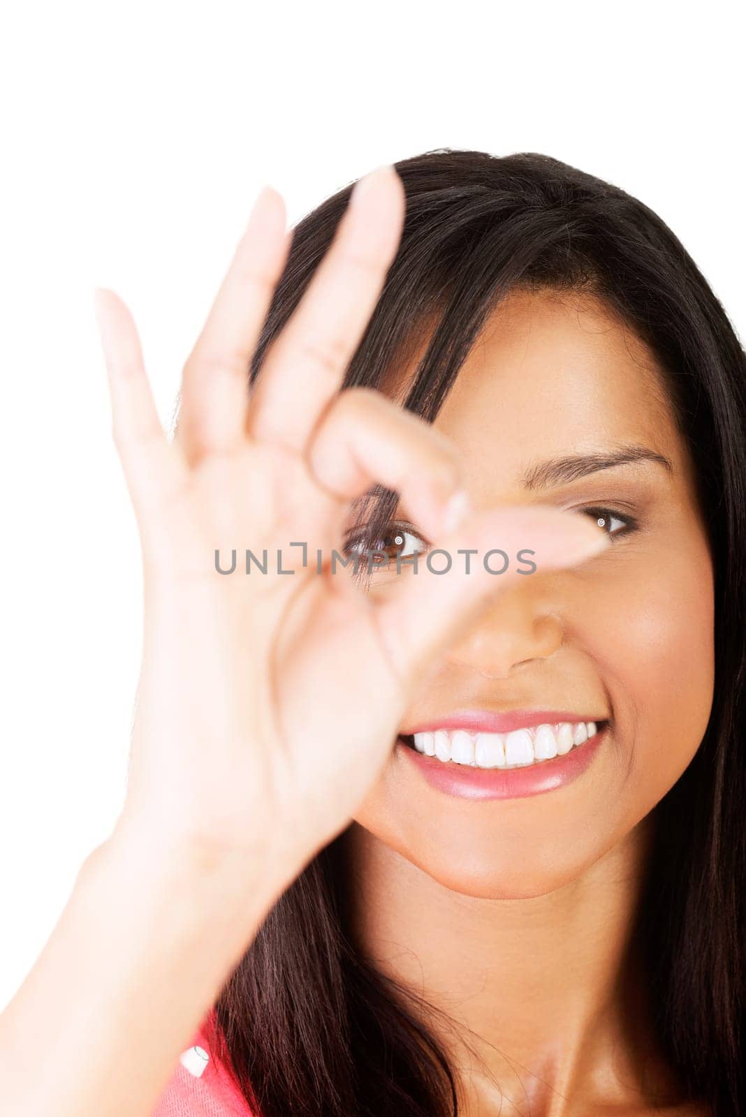 Beautiful young success woman giving perfect gesture standing on white background.
