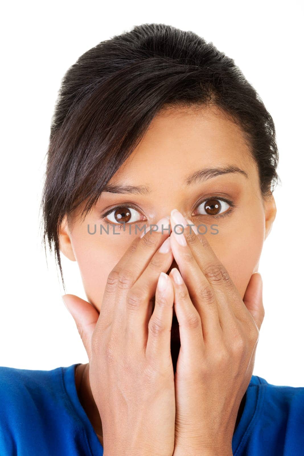 Young scared woman covering the mouth. Isolated on the white background.