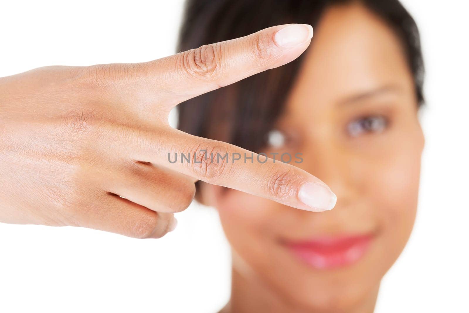 Happy young teenager girl showing victory sign ,isolated on white background