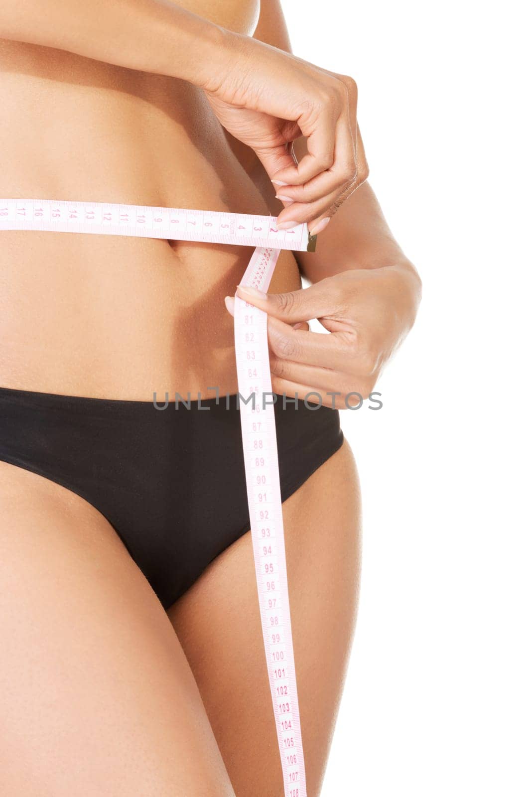 Slim fit woman with measure tape measuring her waist , isolated on white background