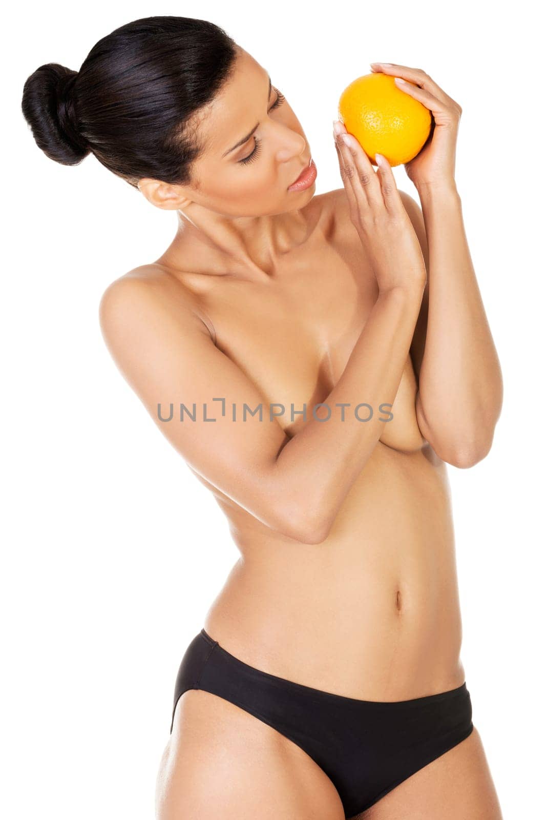Young beautiful spa woman with orange in her hand, isolated on white