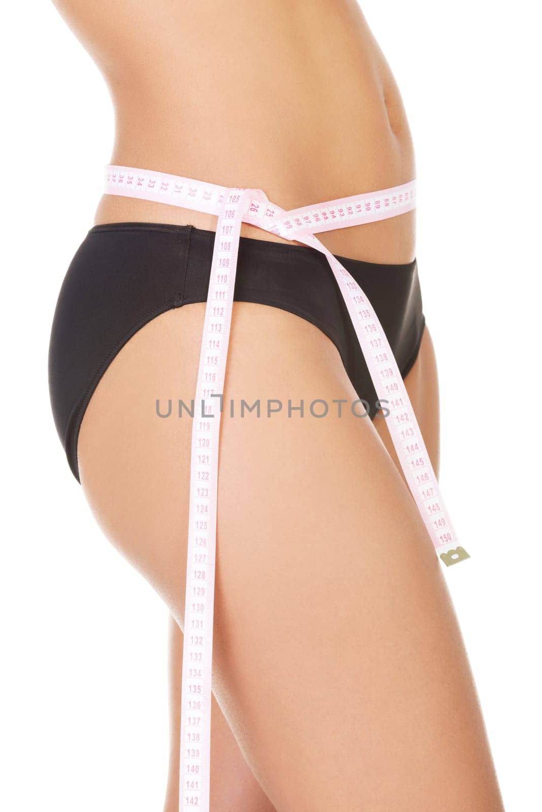 Slim fit woman with measure tape measuring her waist , isolated on white background