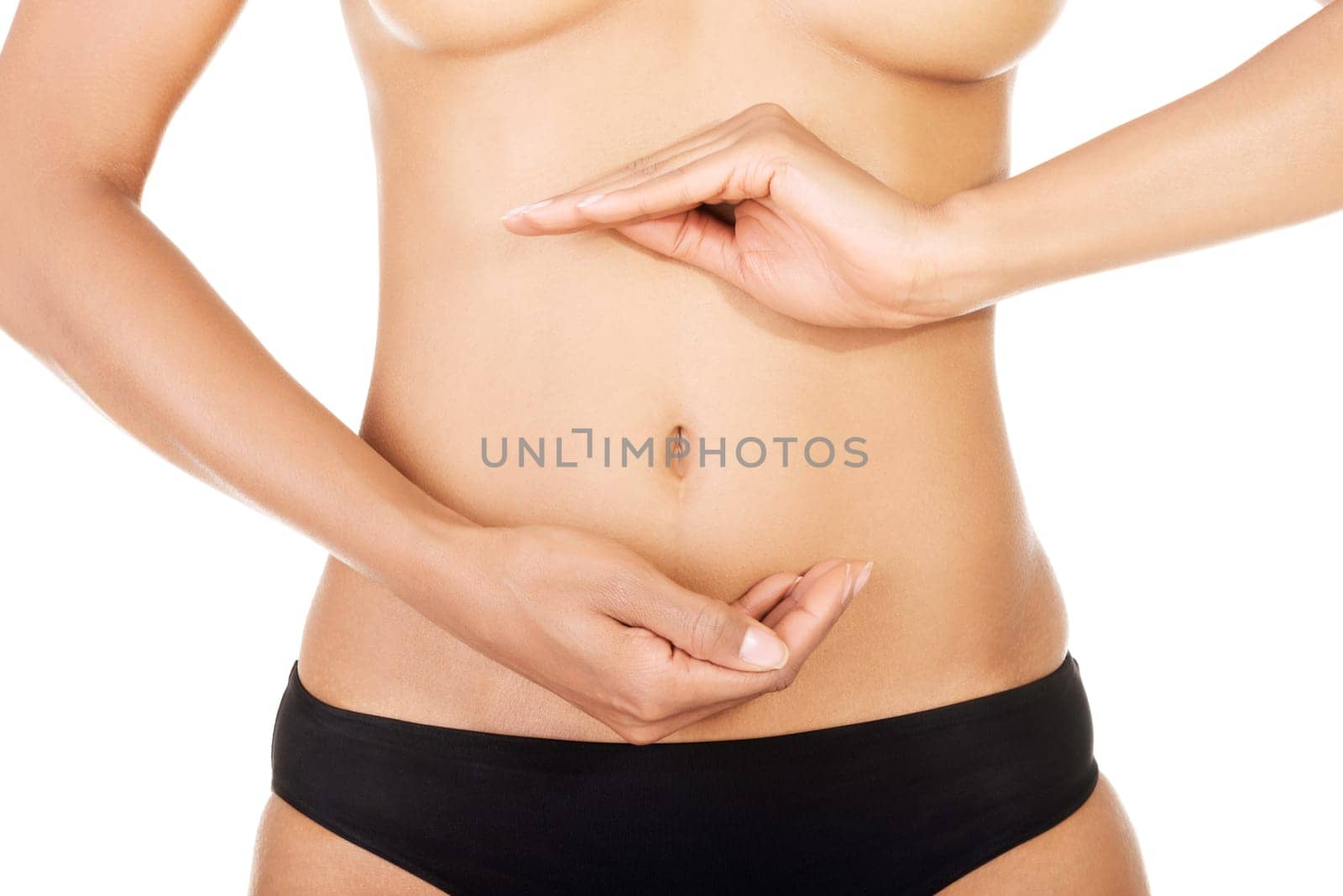 Fit and slim young woman belly with hand on it