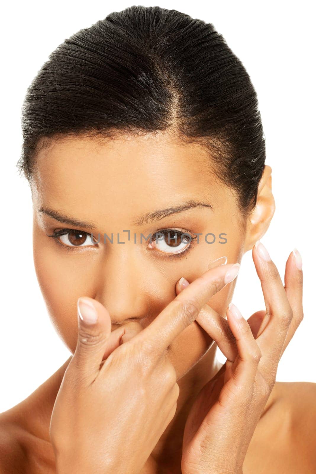 Close up of a woman putting contact lens in her eye