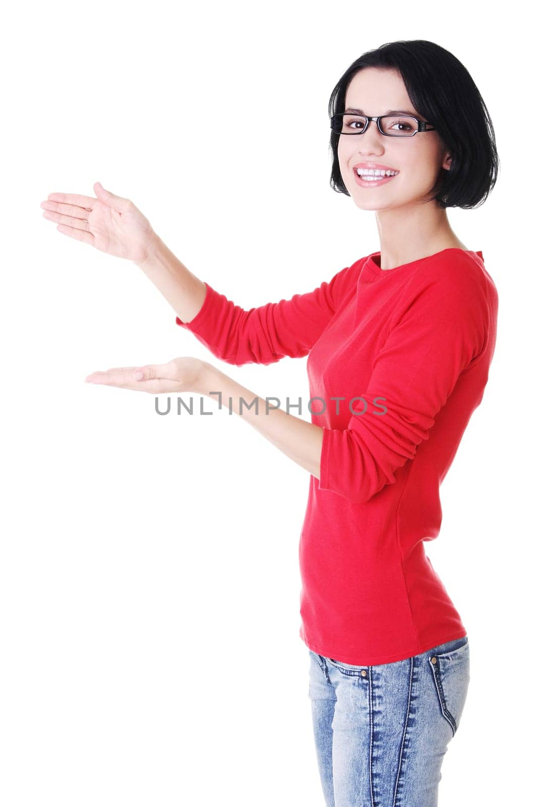 Happy , excited young woman presenting copy space on her palm, isolated on white