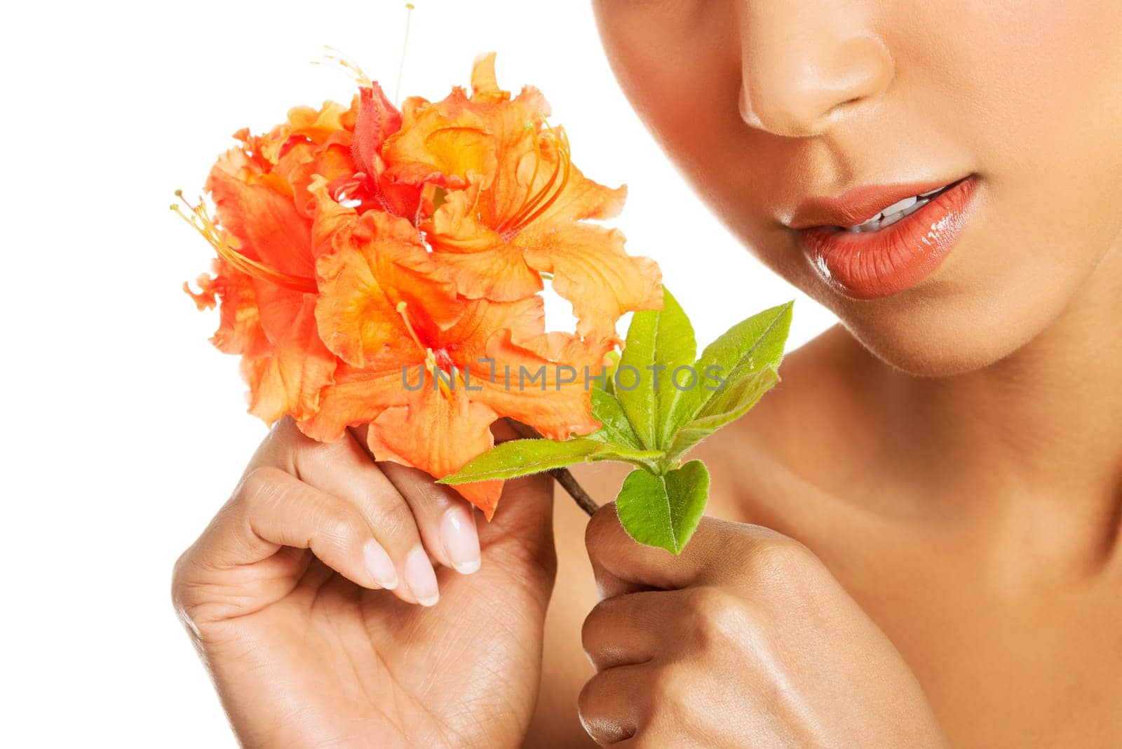 Portrait of beautiful young exotic woman with health skin and with flower