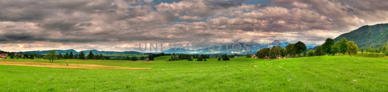 Panorama picture in the Allgäu / Bavaria with overcast skies in summer  panoramic composed from multiple images
