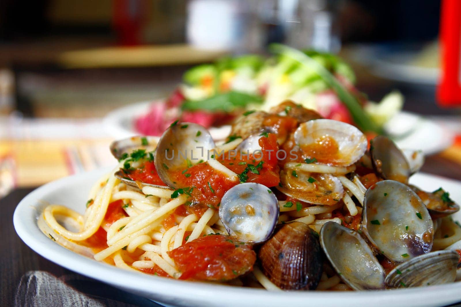 Close view of a tasty and typical spaghetti with clams dish from Italian cuisine.
