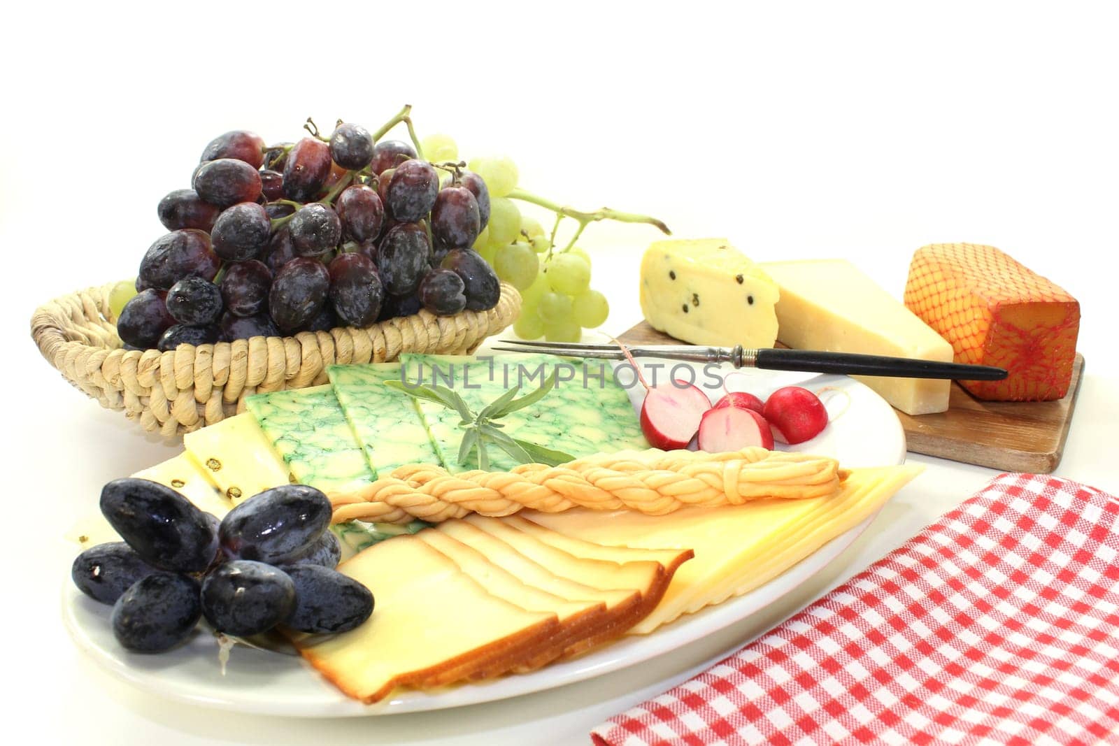 a white plate with different cheeses