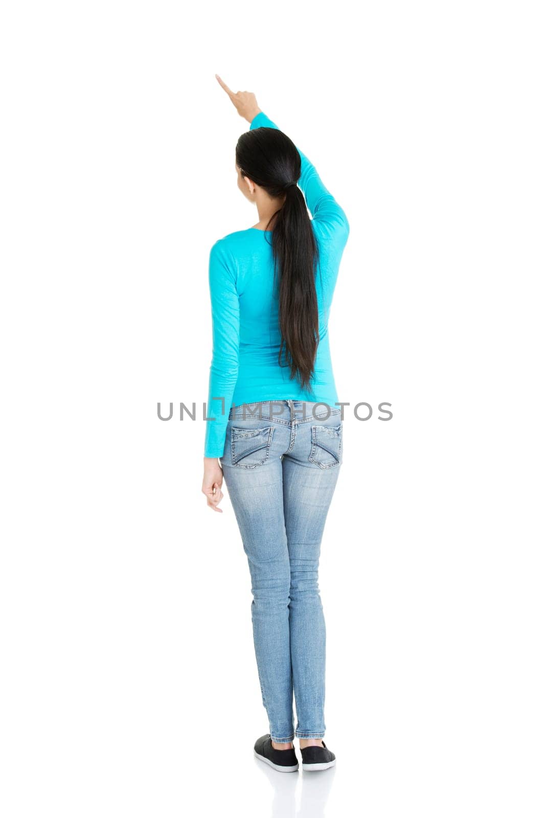 Happy , excited young woman pointing on copy space, isolated on white