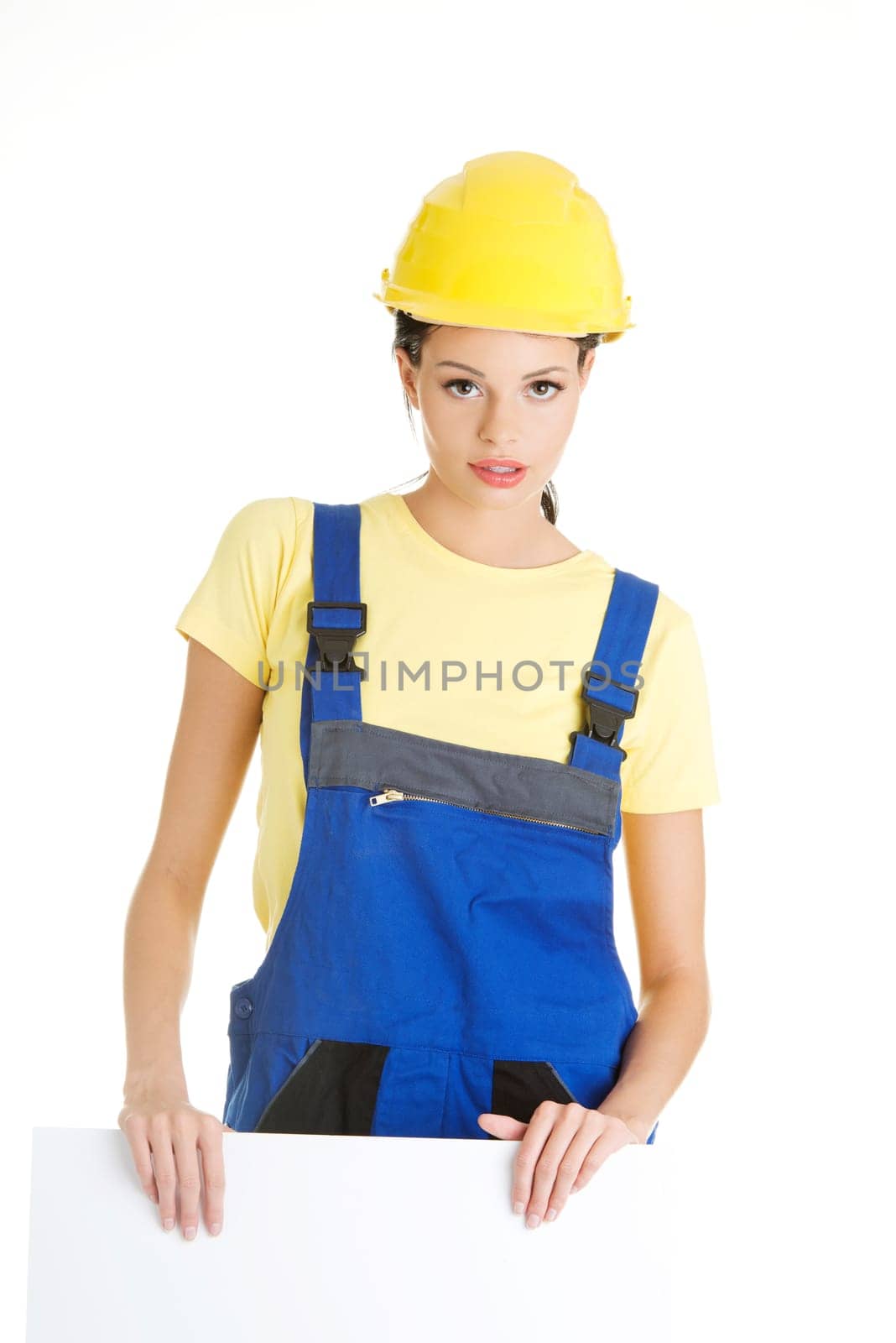 Female construction worker with blank board, isolated on white