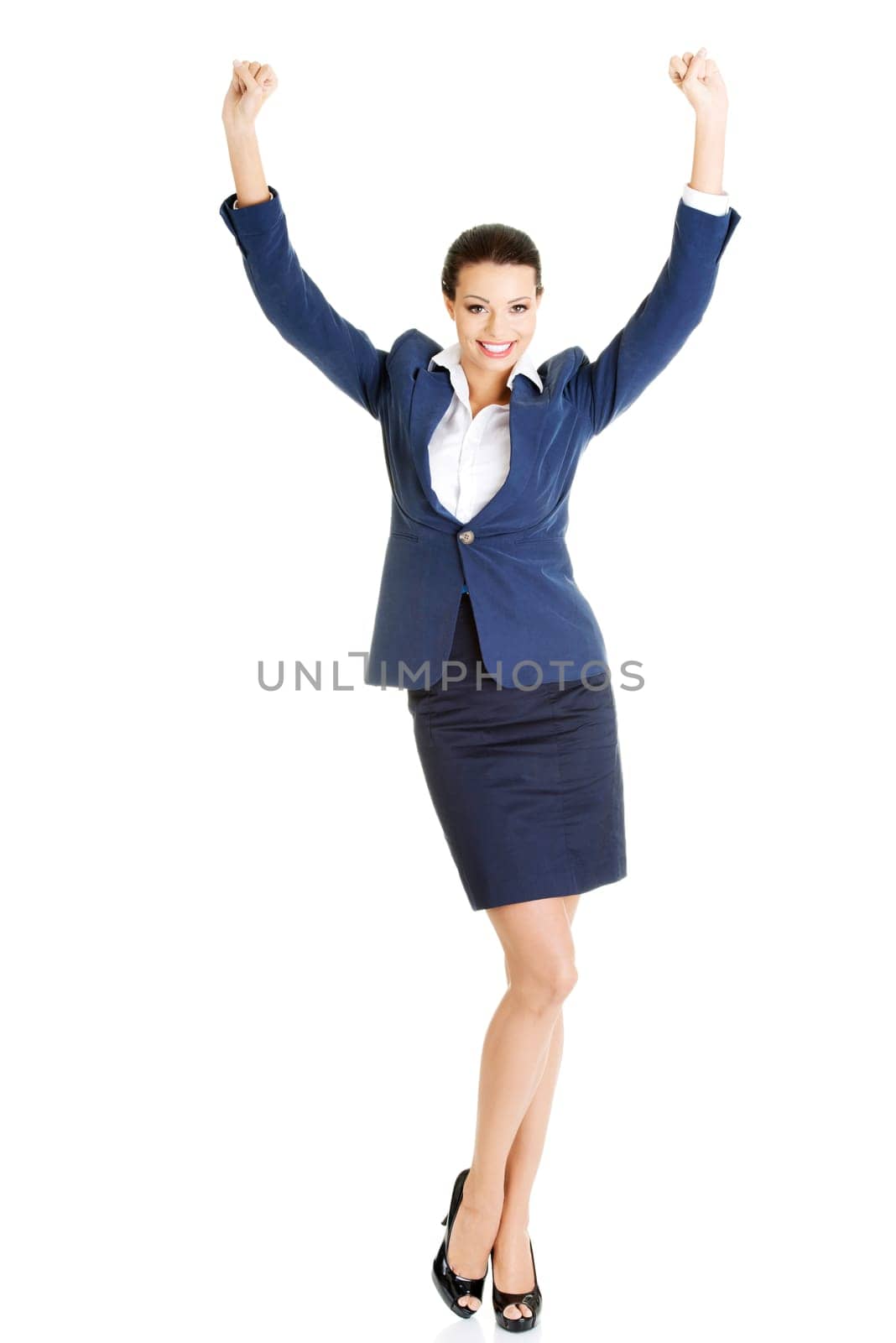 Young happy businesswoman with hands up, isolated on white