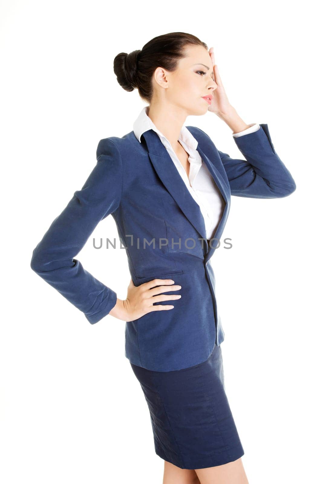 A businesswoman with a headache holding head, isolated on white background