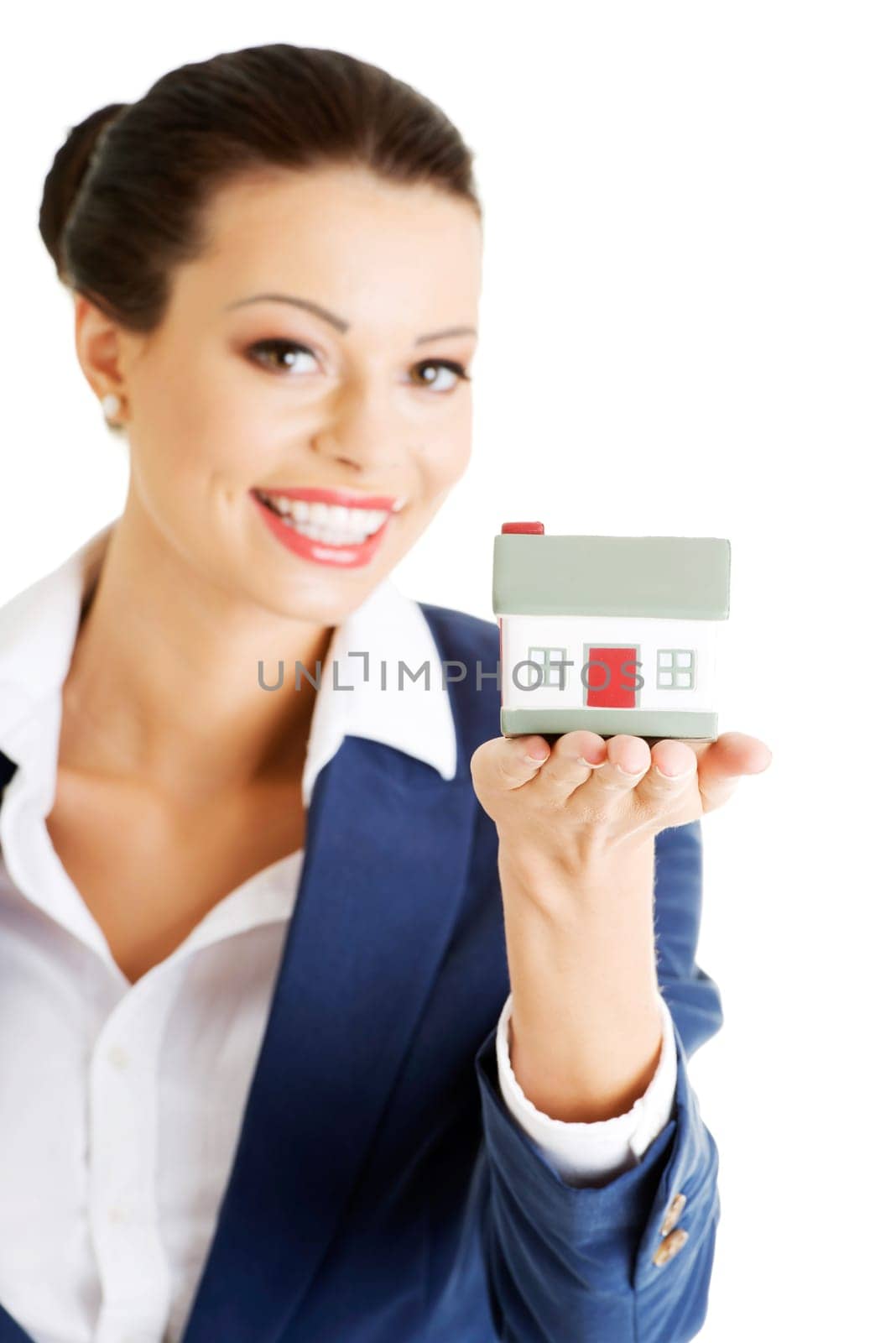Female businesswoman holding and protecting house. Home protecting concept for insurance or security or real estate