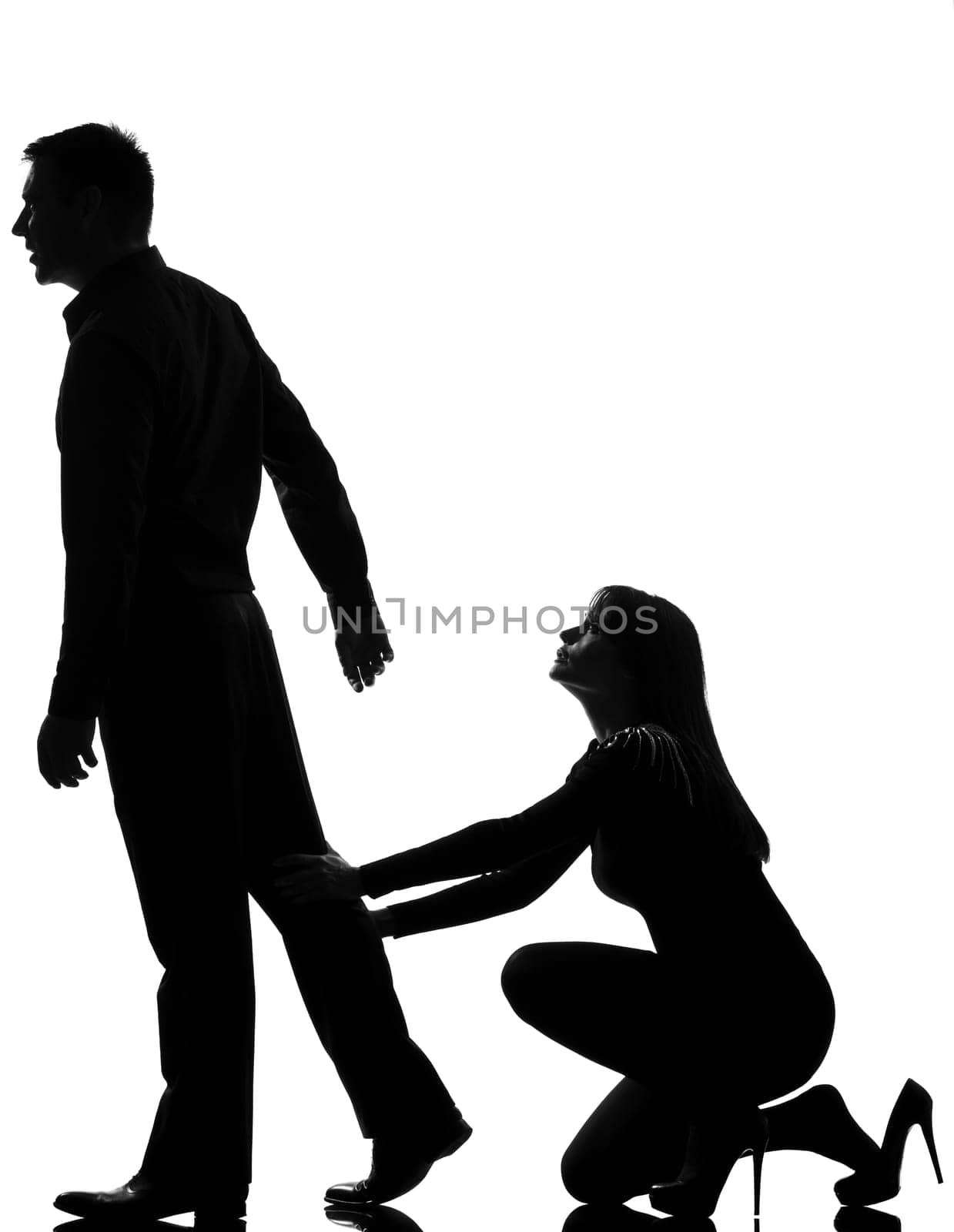 one caucasian couple dispute separation man leaving and woman holding back in studio silhouette isolated on white background