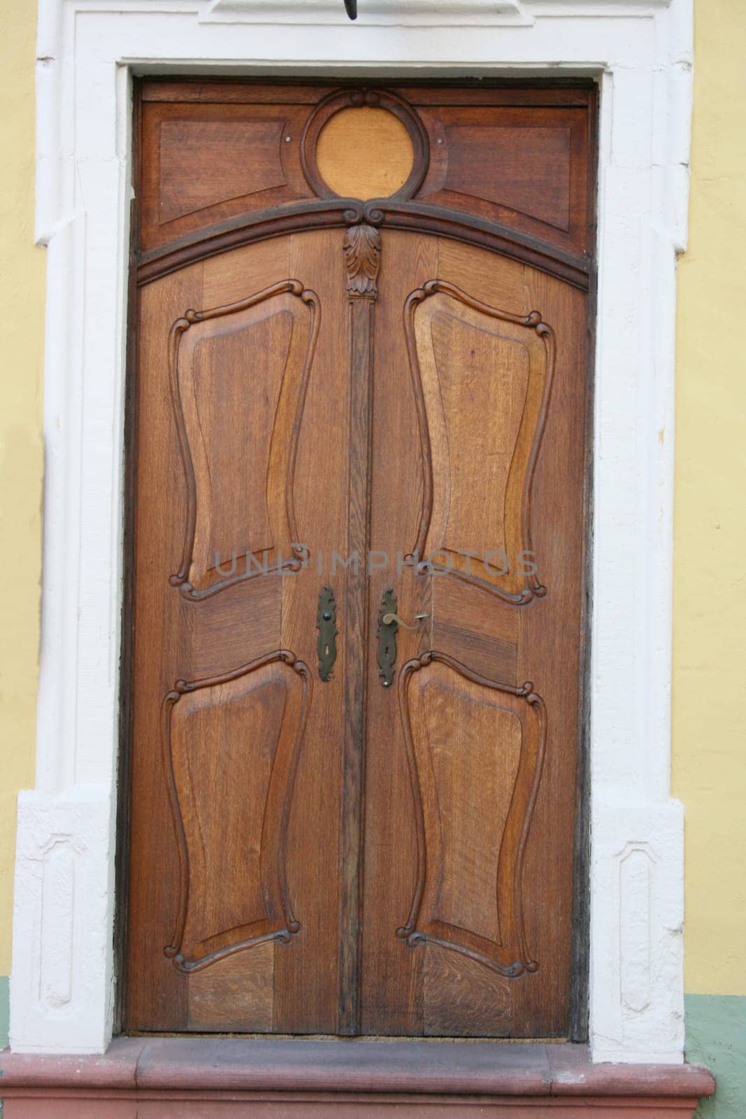 an old decorated wooden front door,with fancy pattern