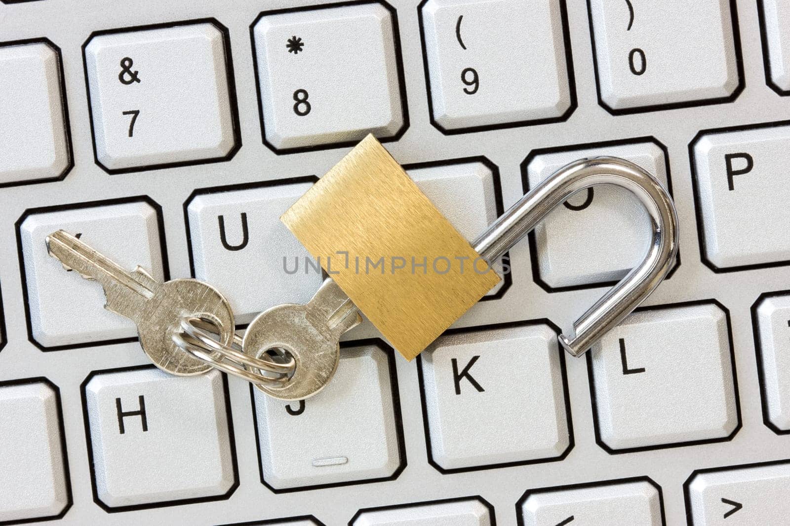 Unlocked padlock with a keys on the computer keyboard