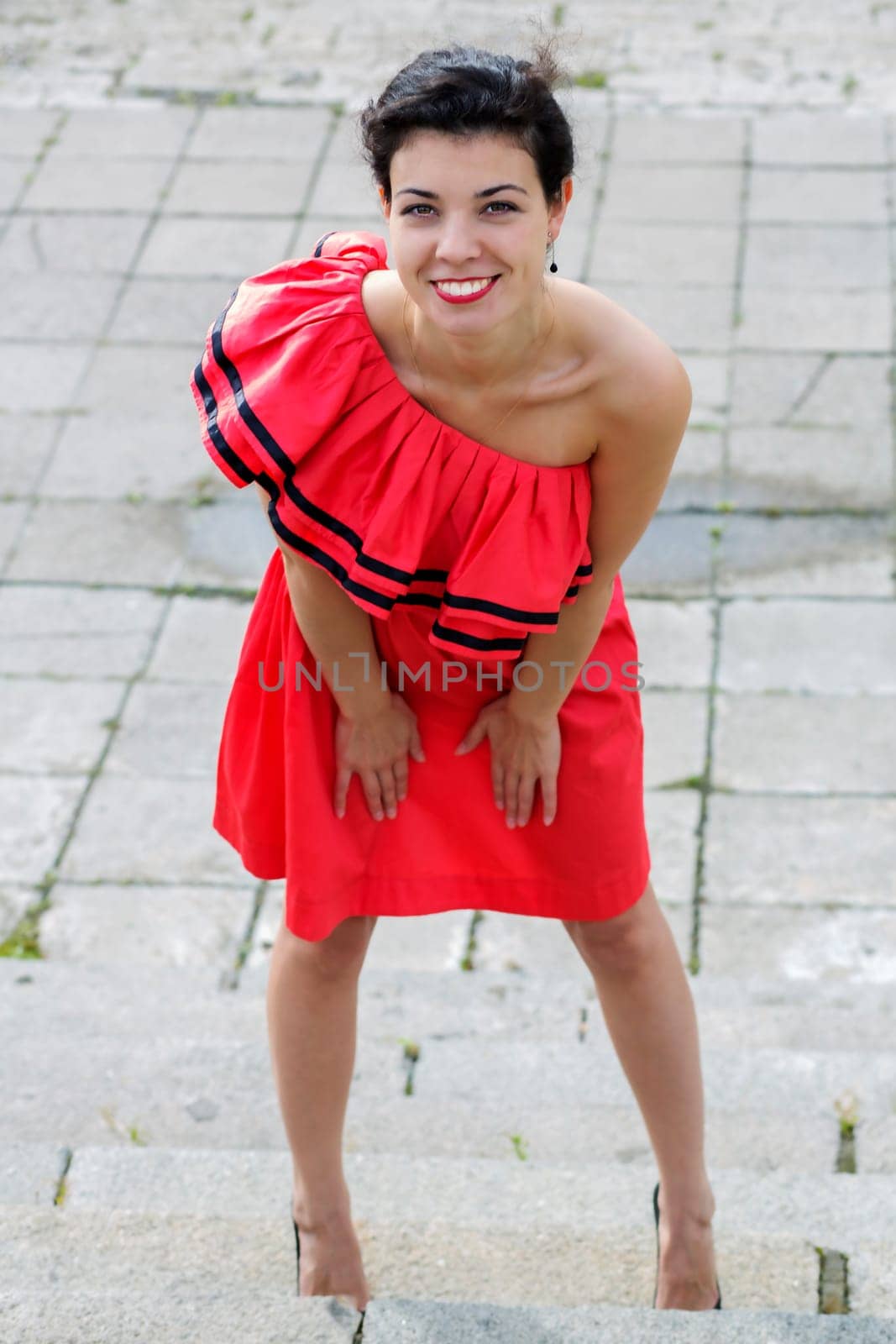 Woman in nice red dress smile at square