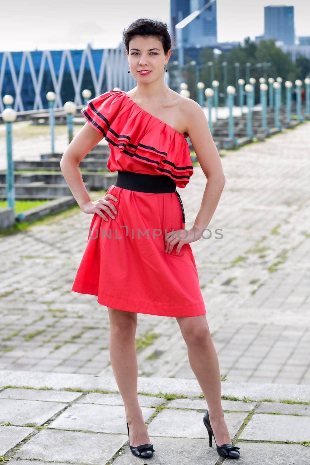 Woman in nice red dress stand at square
