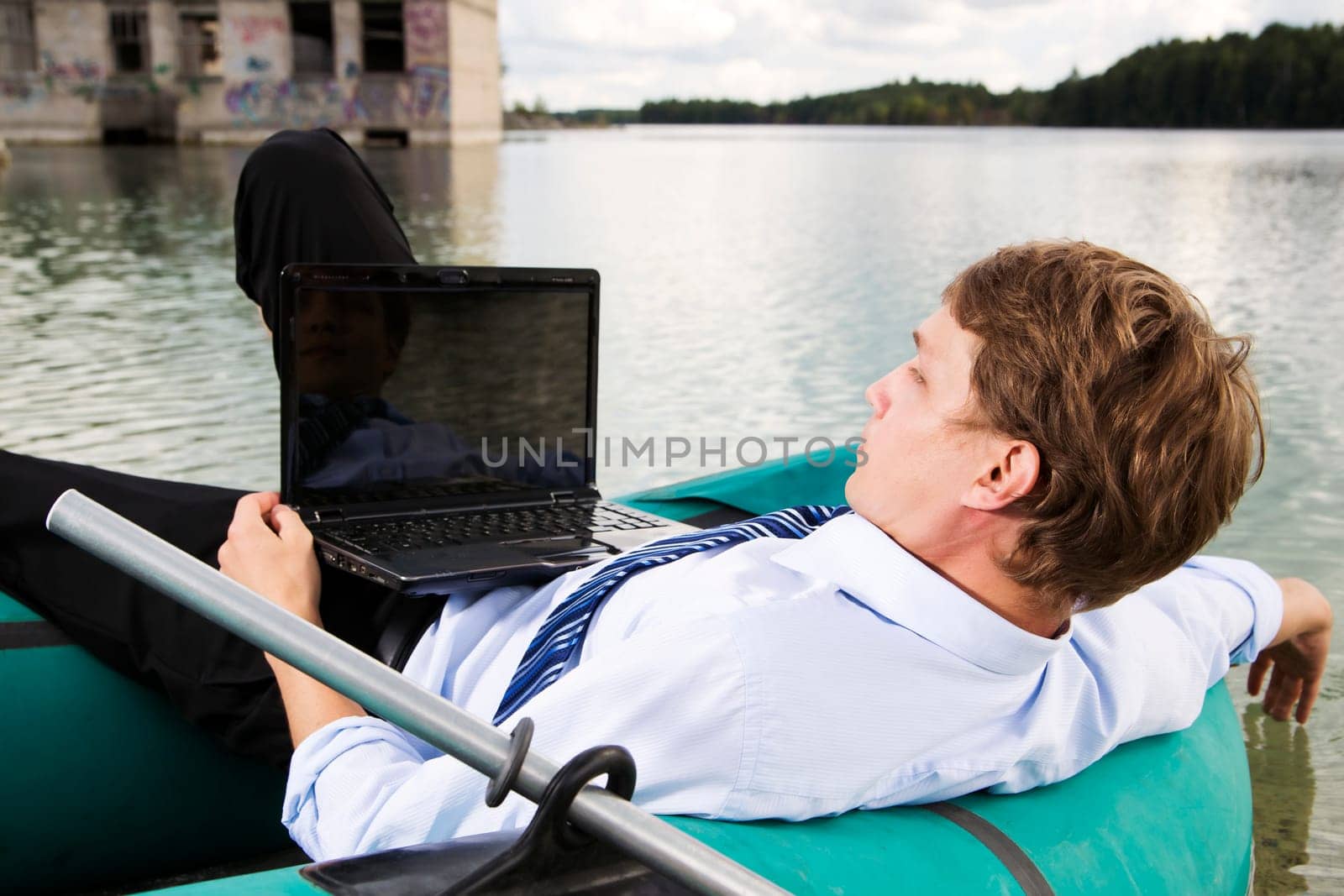 Man in costume lay over boat on lake